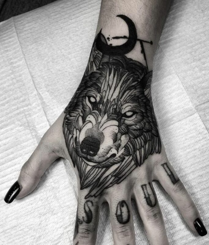 tatuaje de lobo en mano